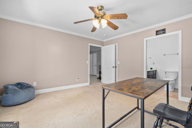 carpeted home office featuring ceiling fan and crown molding