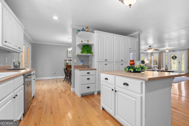 kitchen featuring white cabinetry, a center island, light hardwood / wood-style floors, and stainless steel dishwasher