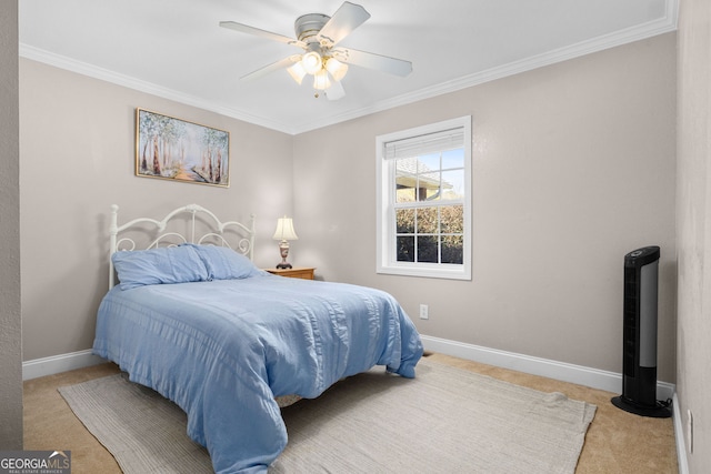 carpeted bedroom with ceiling fan and crown molding