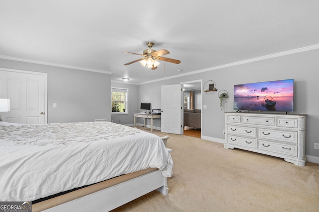 carpeted bedroom featuring ceiling fan and crown molding