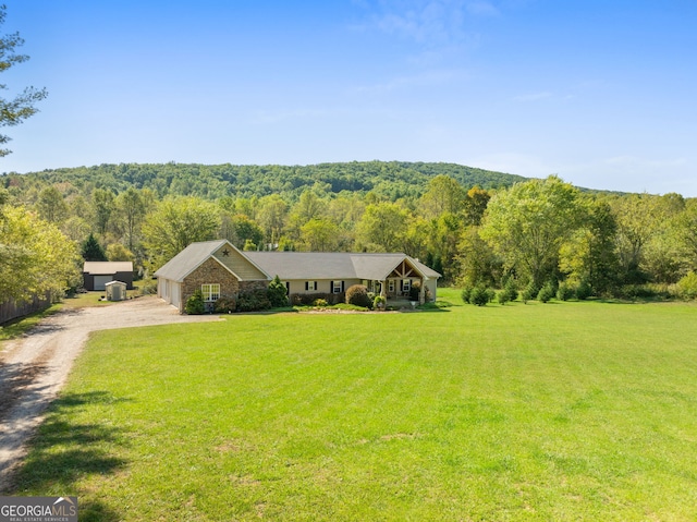 ranch-style home featuring a front yard and a garage