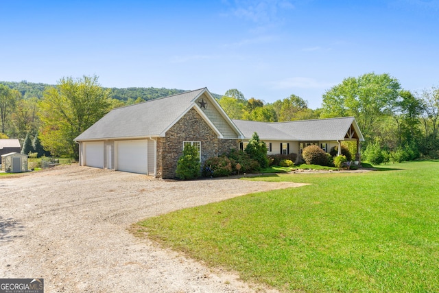 view of front of home with a front yard and a garage