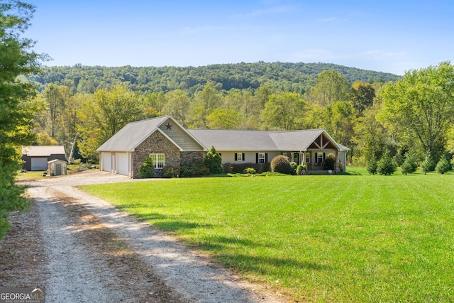 ranch-style house with a front yard and a garage