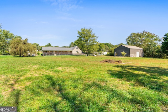 view of yard with an outbuilding and a rural view