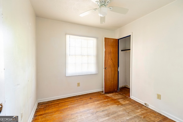 unfurnished bedroom with light wood-type flooring and ceiling fan