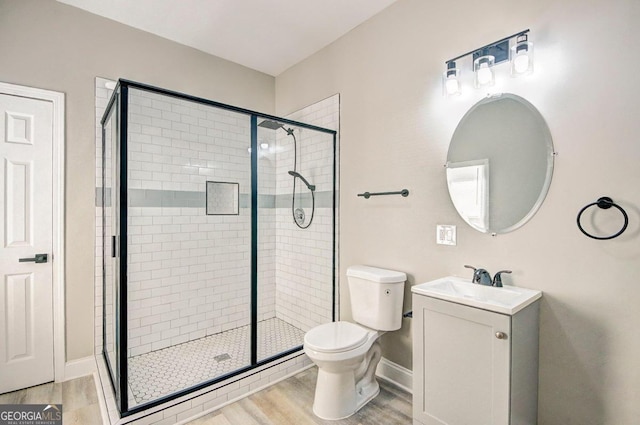 bathroom featuring vanity, hardwood / wood-style floors, toilet, and an enclosed shower