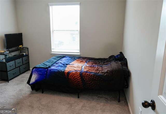 bedroom with light colored carpet