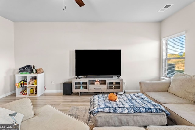 living room with ceiling fan and light wood-type flooring