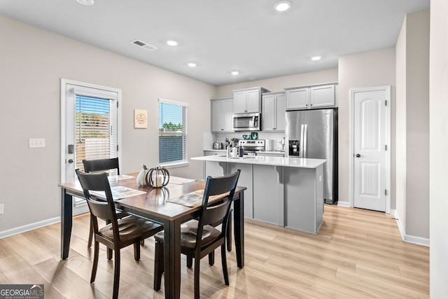 dining area featuring light hardwood / wood-style flooring and sink