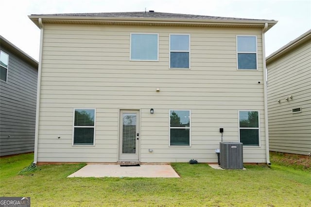 back of property with a lawn, central air condition unit, and a patio