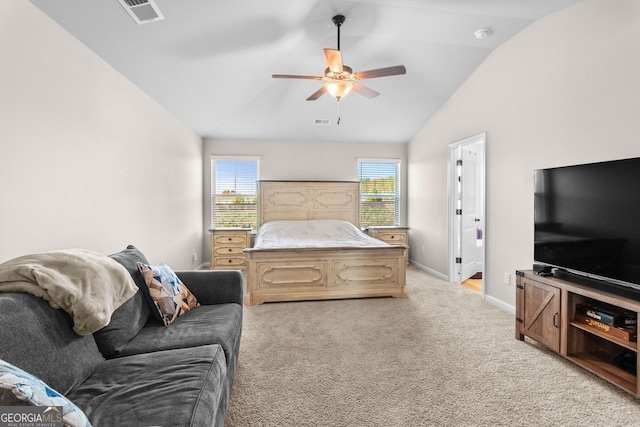 carpeted bedroom with ceiling fan and vaulted ceiling