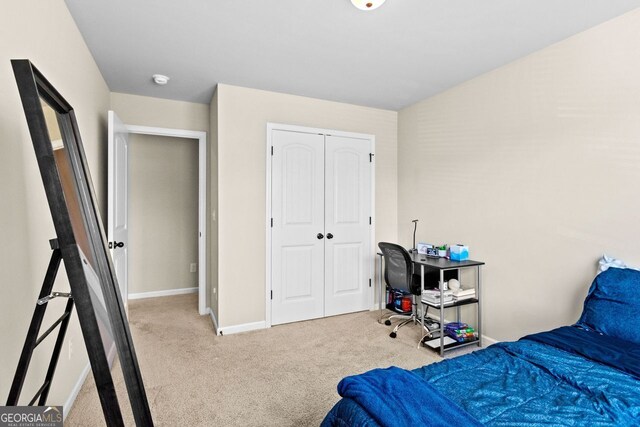 bedroom with light carpet and a closet