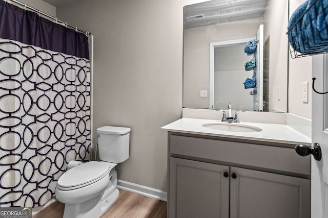 bathroom featuring vanity, toilet, and wood-type flooring