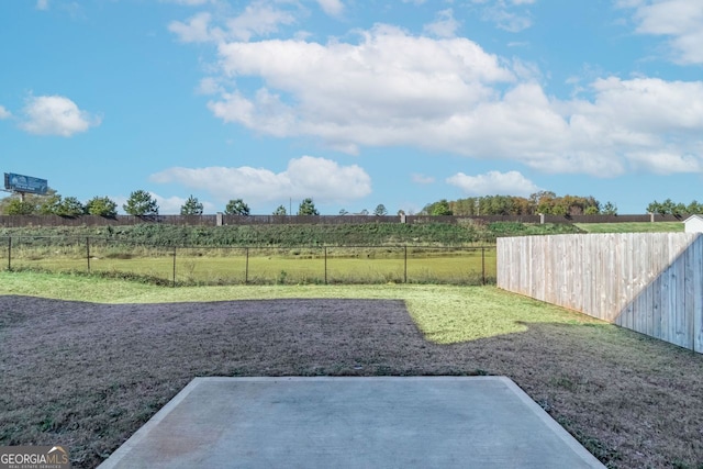 view of yard featuring a rural view and a patio area