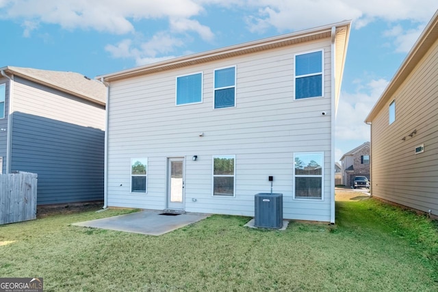 back of property with central AC unit, a yard, and a patio