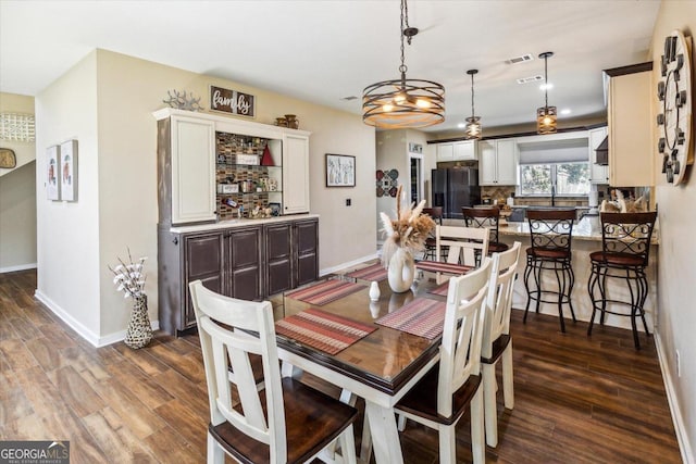 dining area featuring dark wood-type flooring