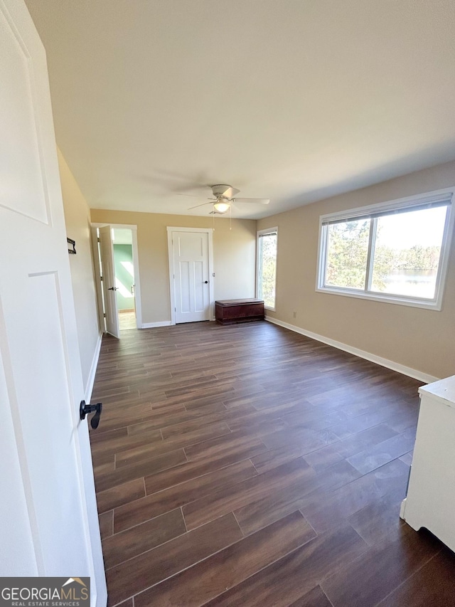 unfurnished room featuring ceiling fan and dark hardwood / wood-style flooring