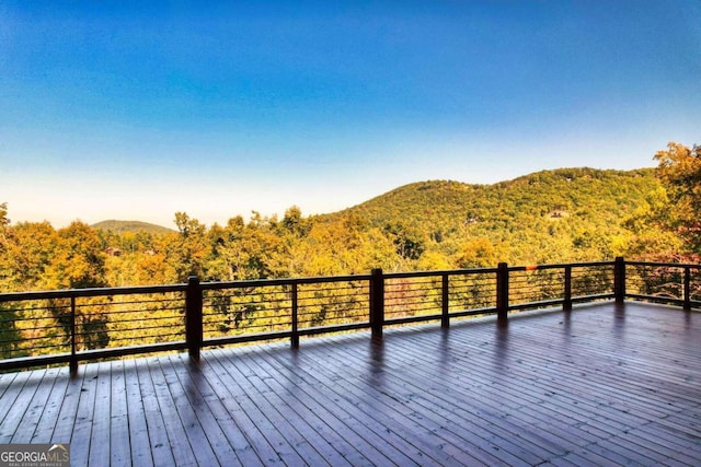 wooden terrace featuring a mountain view