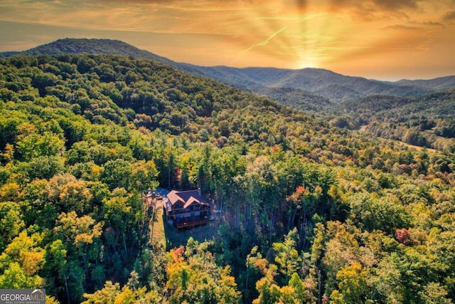 aerial view at dusk featuring a mountain view