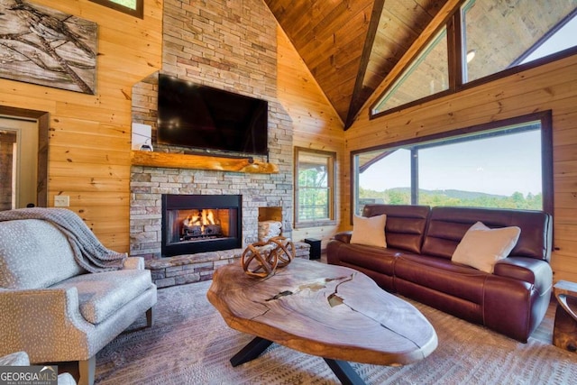 living room featuring high vaulted ceiling, a stone fireplace, wooden ceiling, and wooden walls