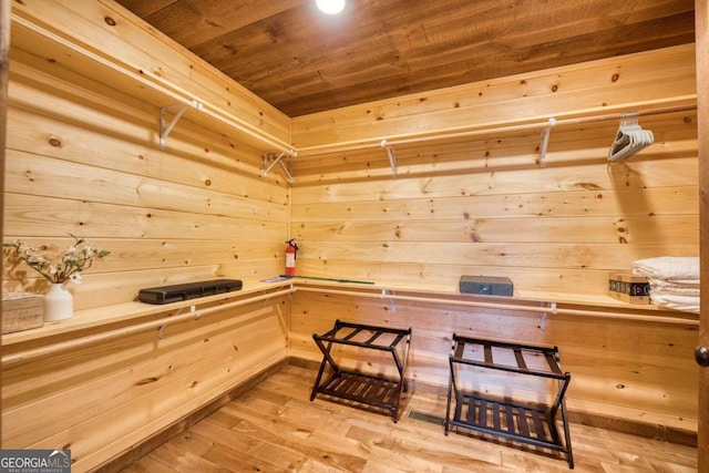 view of sauna / steam room with wood ceiling, wood walls, and hardwood / wood-style floors