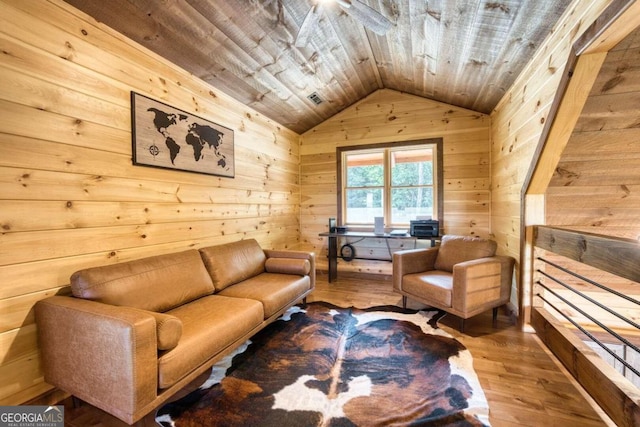 living area with hardwood / wood-style floors, wooden walls, vaulted ceiling, and wooden ceiling