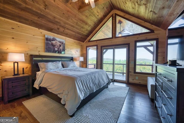 bedroom featuring dark wood-type flooring, wood walls, vaulted ceiling, and access to exterior