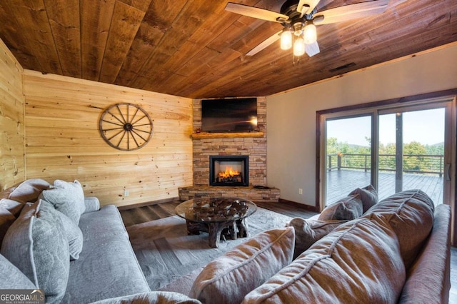 living room featuring wood walls, wooden ceiling, dark hardwood / wood-style flooring, and a fireplace