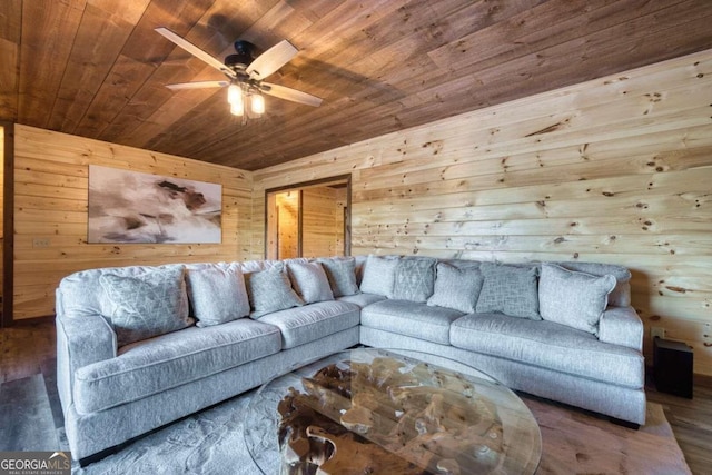 living room with ceiling fan, wood ceiling, wood-type flooring, and wood walls