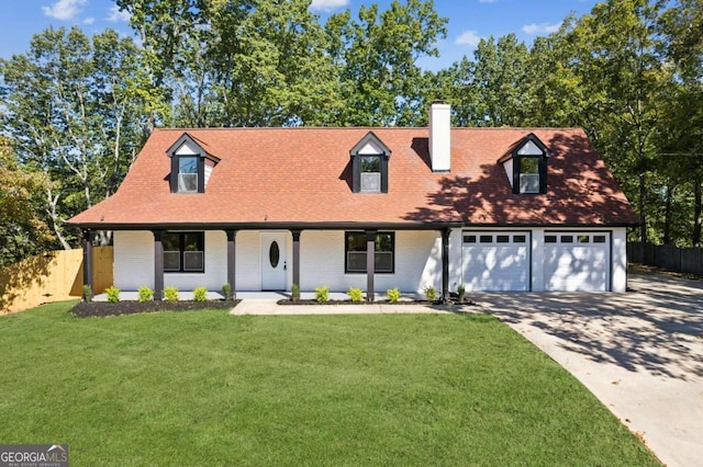 cape cod-style house featuring a front yard and a garage