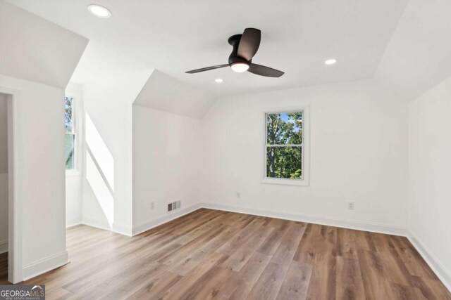 additional living space with ceiling fan, vaulted ceiling, and light hardwood / wood-style floors