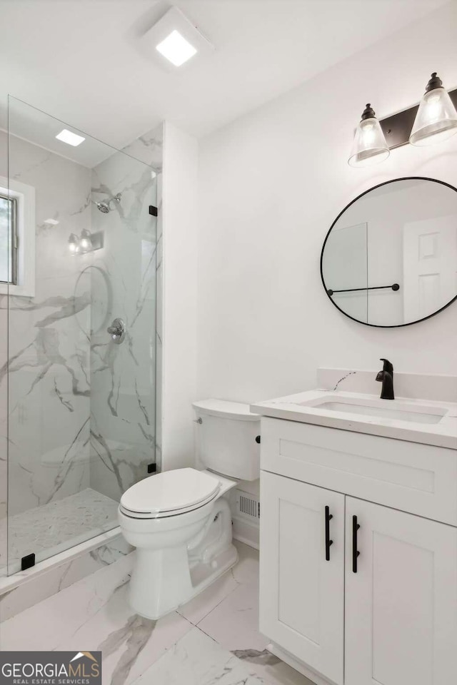 bathroom featuring toilet, tiled shower, and vanity