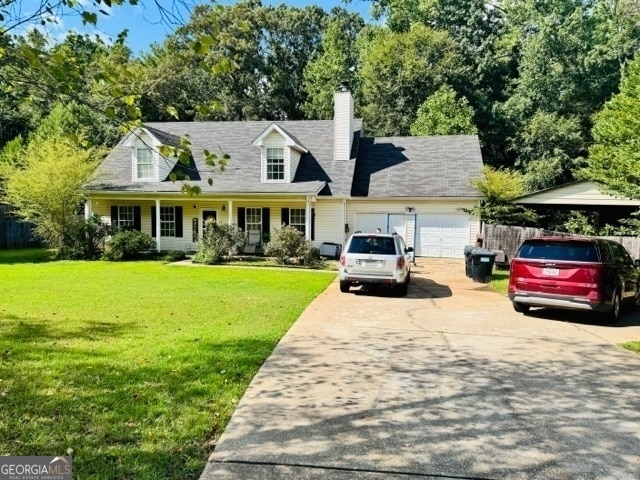 cape cod-style house with a front yard and a garage