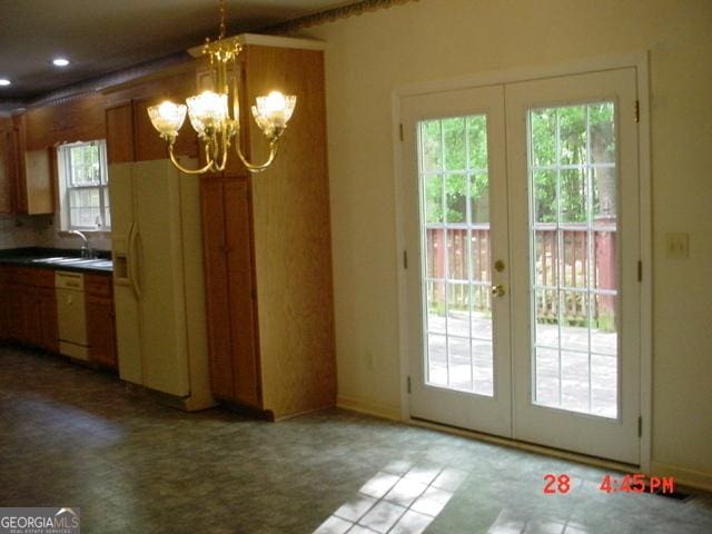 interior space with a notable chandelier, sink, and french doors