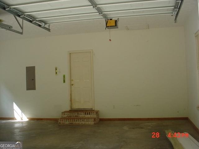 garage with electric panel and a garage door opener