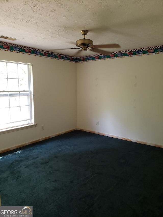 unfurnished room featuring carpet, ceiling fan, and a textured ceiling