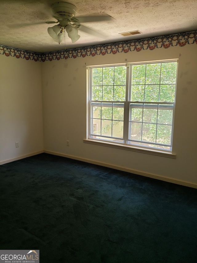87 Mcmichael Way, Hoschton, GA 30548 - unfurnished room with ceiling fan, baseboards, dark carpet, and a textured ceiling