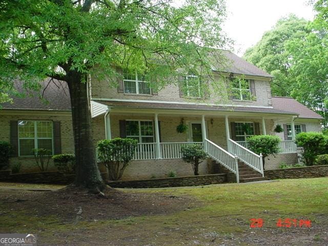 87 Mcmichael Way, Hoschton, GA 30548 - view of front of property featuring covered porch
