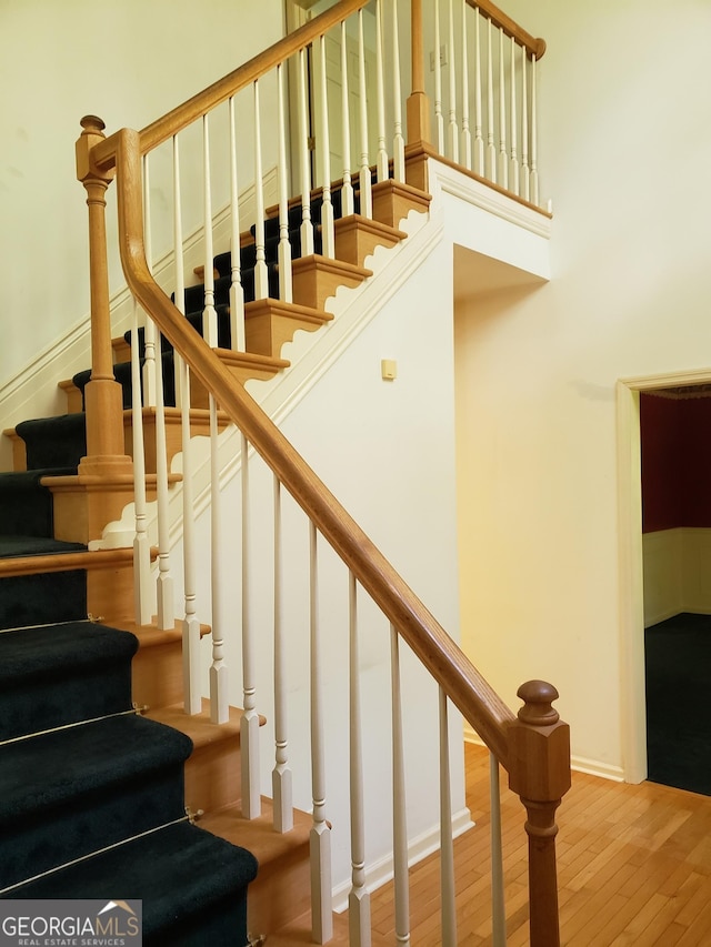 stairs with hardwood / wood-style floors