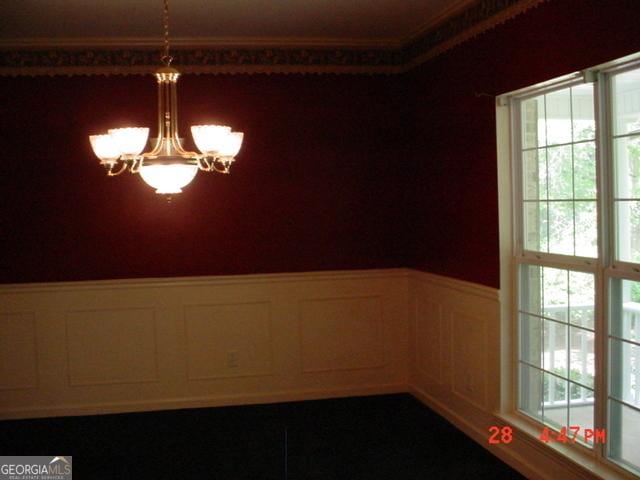 spare room with a chandelier