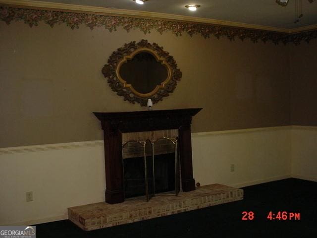 unfurnished living room with a brick fireplace and crown molding