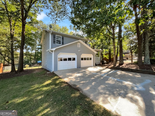 view of side of property with a garage and a yard