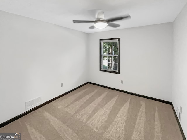 unfurnished room with ceiling fan and carpet flooring