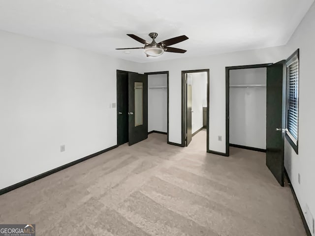 unfurnished bedroom featuring ceiling fan and light carpet