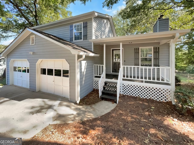 front facade with covered porch and a garage