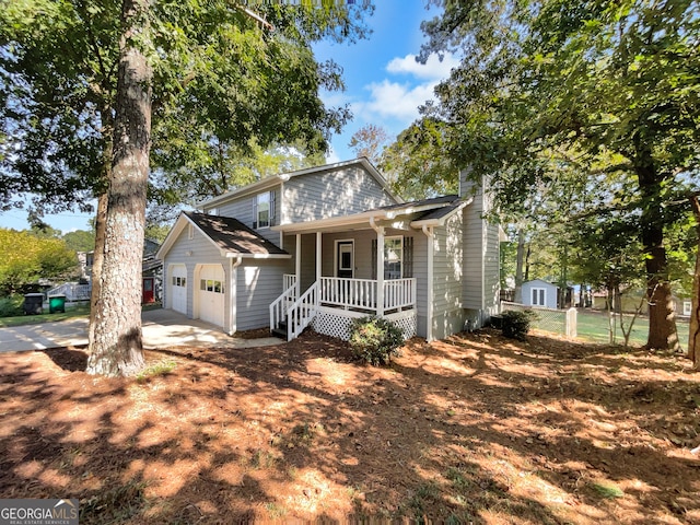 view of front of property featuring a garage, a porch, and an outdoor structure