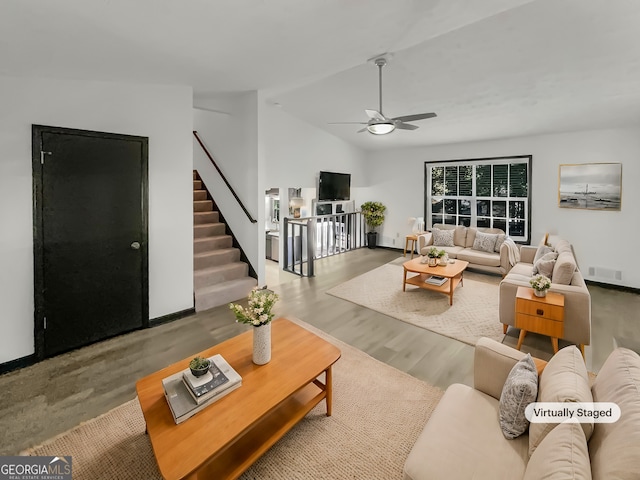 living room featuring lofted ceiling, hardwood / wood-style flooring, and ceiling fan