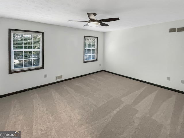 empty room featuring ceiling fan and carpet flooring