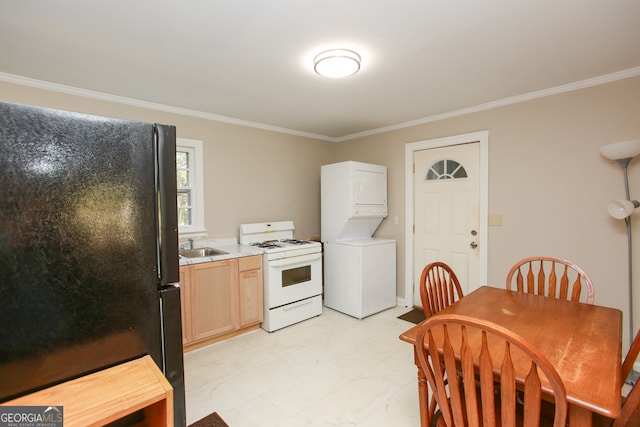 kitchen featuring stacked washer and dryer, black fridge, gas range gas stove, crown molding, and light brown cabinetry