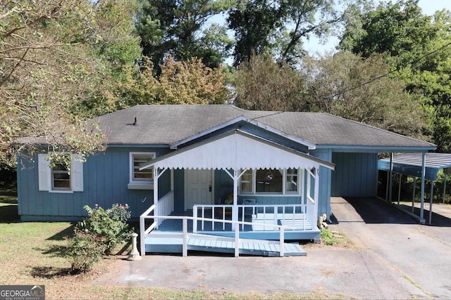 view of front of property featuring a wooden deck and a carport